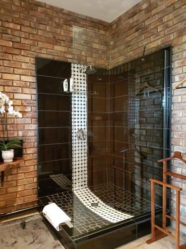 a glass shower in a brick wall at MyAula in Tierpoort