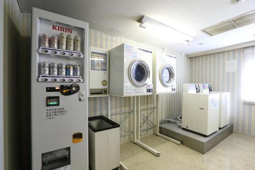 a laundry room with a washer and dryer at Shin Osaka Esaka Tokyu REI Hotel in Suita