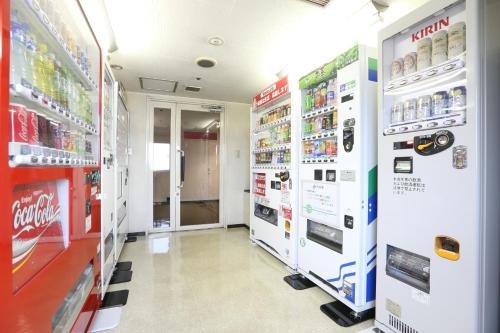 a pharmacy aisle with vending machines in a store at Shin Osaka Esaka Tokyu REI Hotel in Suita