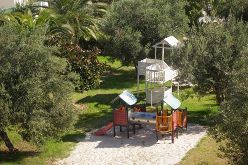 a playground in a garden with a play equipment at El Mouradi Club Kantaoui in Port El Kantaoui