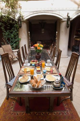 a wooden table with food and drinks on it at Riad Lorsya in Marrakech