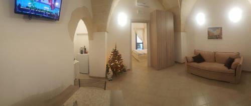 a living room with a christmas tree and a couch at ALIMAR B&B in Lizzano
