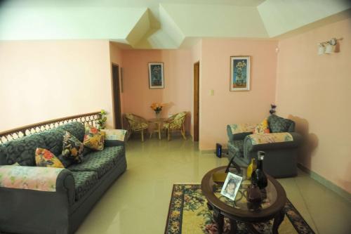 a living room with two couches and a table at Eagle's Nest in Montego Bay