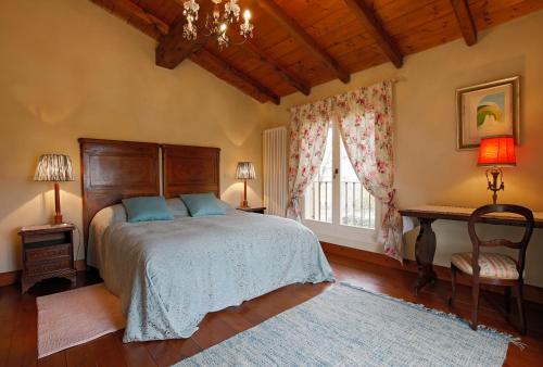 a bedroom with a bed and a window and a chandelier at Belvedere in Zola Predosa