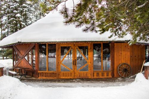 a wooden cabin with snow on the roof at Lake Louise Inn in Lake Louise