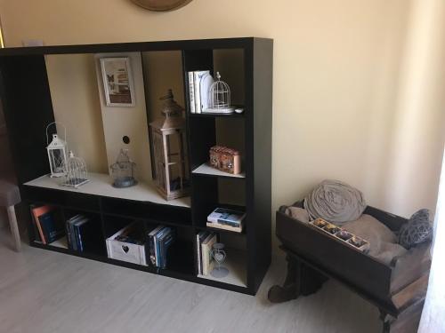 a black book shelf with a chair in a room at Aquarius Inn in Rome