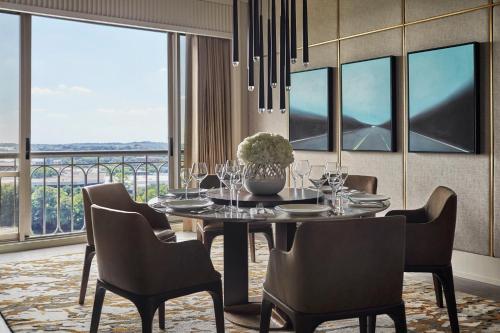 a dining room with a table and chairs and windows at Four Seasons Hotel Austin in Austin