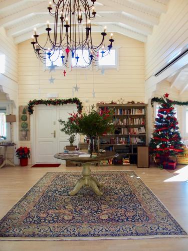 a living room with a table and a christmas tree at Ktima Noosfera Wellness & Retreat Center in Nees Vrisoules