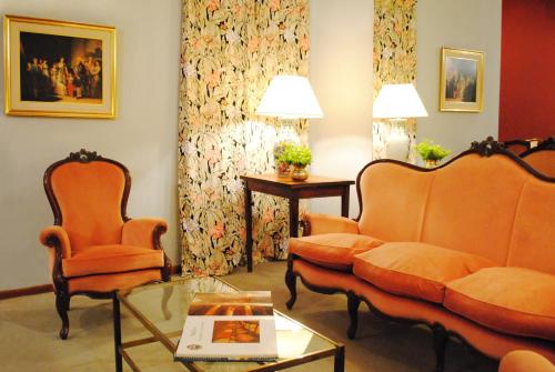 a living room with a couch and chairs and a table at Gran Texier Hotel Casino in Concepción del Uruguay