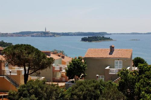 a group of houses with a view of the water at Maistra Select Amarin Resort in Rovinj