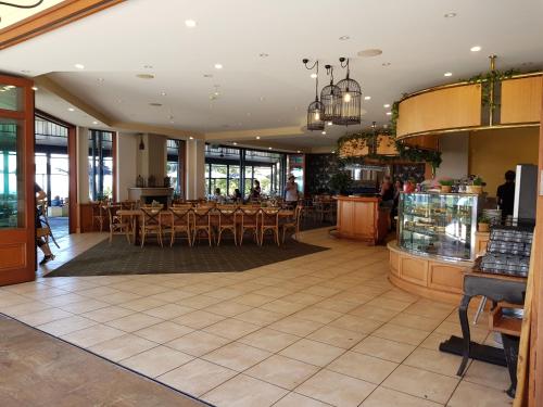 a dining room with tables and chairs in a restaurant at Mayfield on Montville in Montville
