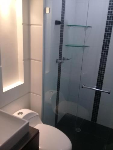 a bathroom with a toilet and a glass shower at Apartamento En Sabaneta in Sabaneta