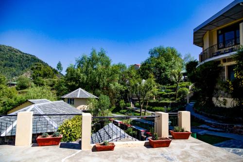 arial view of a house with a garden at Hotel Udechee Huts, McLeod Ganj in McLeod Ganj