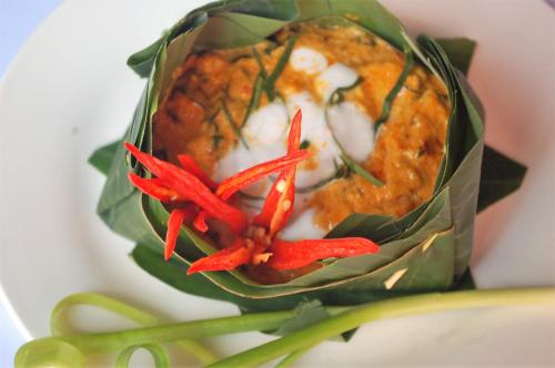 two red peppers are in a green wrap at The Siem Reap Chilled Backpacker in Siem Reap