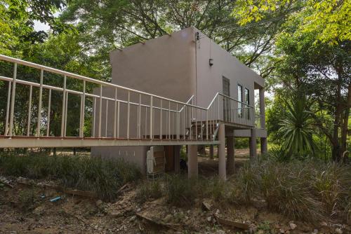 a house with a staircase leading up to it at I love phants Lodge in Ban Huai Thawai