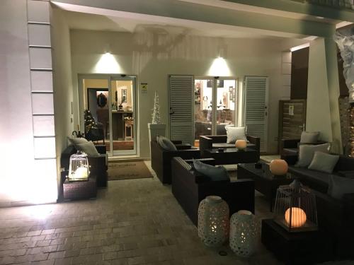 a living room with couches and chairs in a room at Rouge Hotel International in Milano Marittima