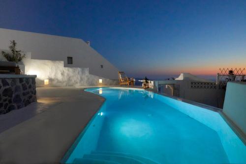 a swimming pool in a villa at night at Senses Boutique Hotel in Imerovigli