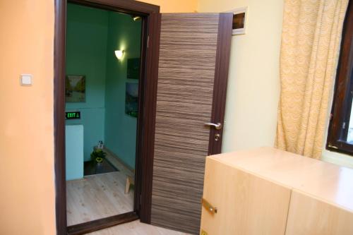 a wooden door in a room with a mirror at Shanti Hostel in Skopje