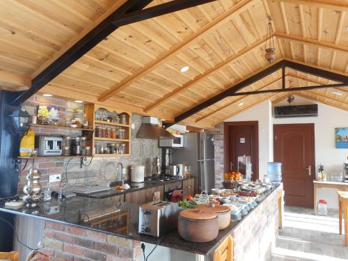 a large kitchen with wooden ceilings and a counter top at Lale Pension in Egirdir