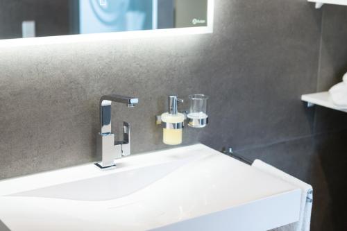 a bathroom with a white sink and a mirror at Altstadt Apartments in Kirchheim unter Teck