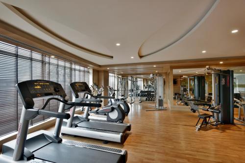 a gym with treadmills and ellipticals in a room at Radisson Gurugram Udyog Vihar in Gurgaon