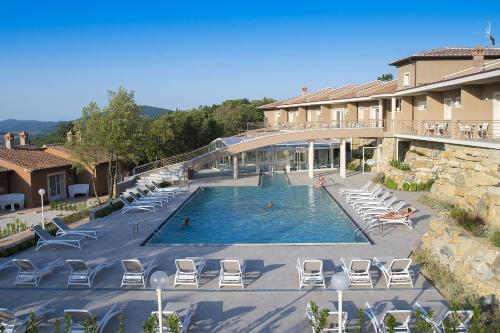 um hotel com piscina e espreguiçadeiras em Relais I Piastroni em Monteverdi Marittimo