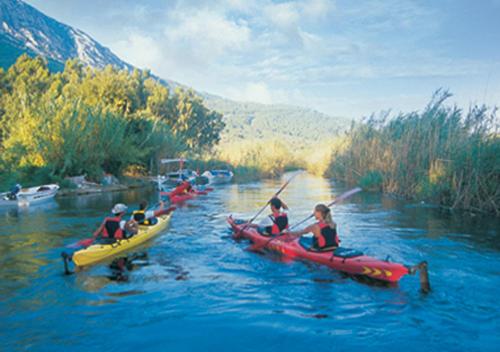 a group of people in kayaks on a river at Yucelen Hotel in Akyaka