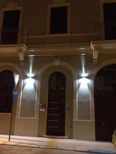a building with a black door with lights on it at L'arco di porta Lecce in Brindisi