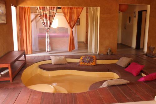a living room with a circular couch in the middle at Le Lodge Dalaal Diam in Somone