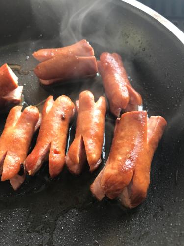 a bunch of bacon being fried in a wok at White Linen Guesthouse in Tierpoort