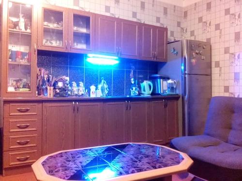 a kitchen with a coffee table in front of a counter at My home udabno in Udabno