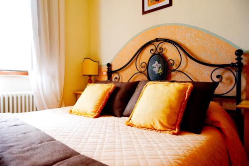 a bedroom with a large bed with two pillows at Residenze L'Uncinaia Holiday House in Perugia
