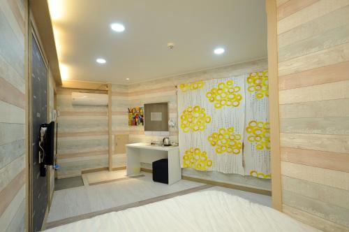 a bathroom with a shower curtain and a sink at Family Hotel BNB in Busan