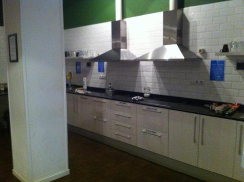 una cucina con elettrodomestici in acciaio inossidabile in una camera di 360 Hostel Centro a Barcellona