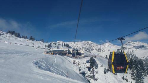 a ski lift going up a snow covered mountain at Appart Bergleben-Deluxe **** in Gerlos