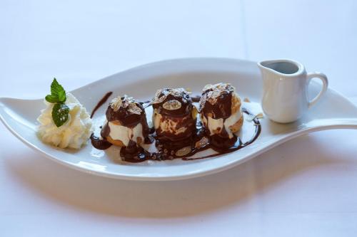 a plate with chocolate desserts and a cup of coffee at hotel brasserie au violon in Basel