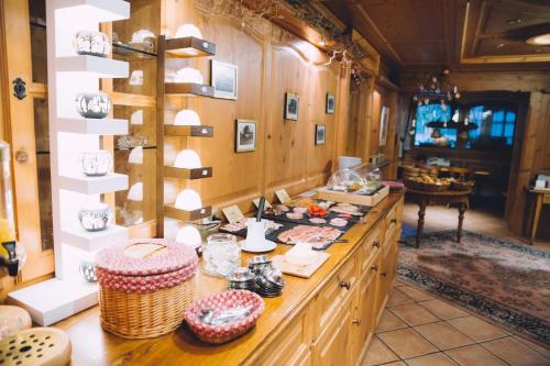 a large room with a counter with food on it at Hotel Tannenmühle in Grafenhausen