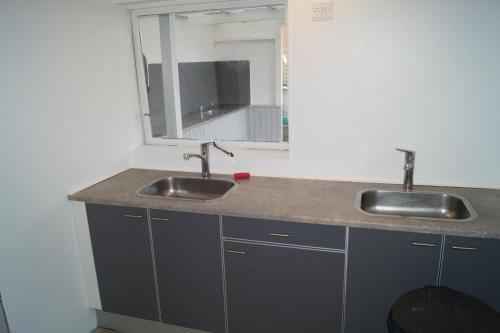 a bathroom with two sinks and a mirror at Kalundborg Camping in Kalundborg