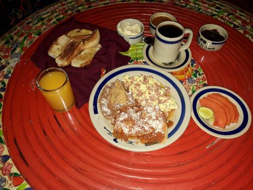 a table with a plate of breakfast food on it at Hotel el Fuerte in El Fuerte