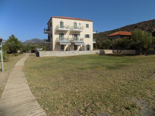 a villa with a large lawn in front of it at Akti Kamares in Kamáres