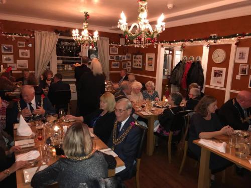 a group of people sitting at tables in a restaurant at Waterfront Hotel in Deal