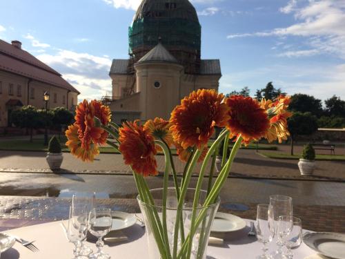 a vase filled with flowers sitting on a table at Liškiavos vienuolyno ansamblis in Liškiava