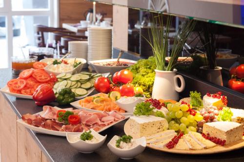 a buffet with many plates of food on a table at Park Resort in Willingen