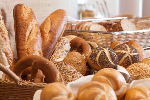a bunch of different types of bread in baskets at Park Resort in Willingen