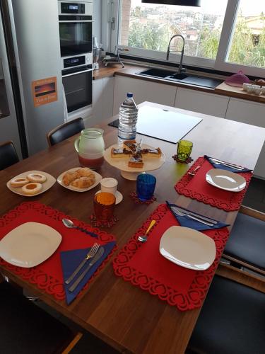 a table with plates of food on it in a kitchen at B&B Vista su Roma in Marco Simone