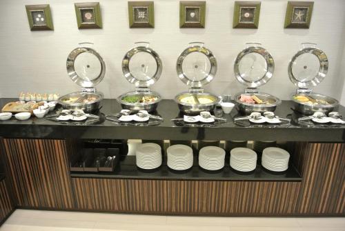 a buffet line with plates and bowls of food at K Hotel Taipei in Taipei
