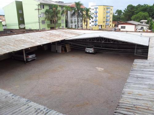 a parking lot with a car under a bridge at City Hotel PF in Passo Fundo
