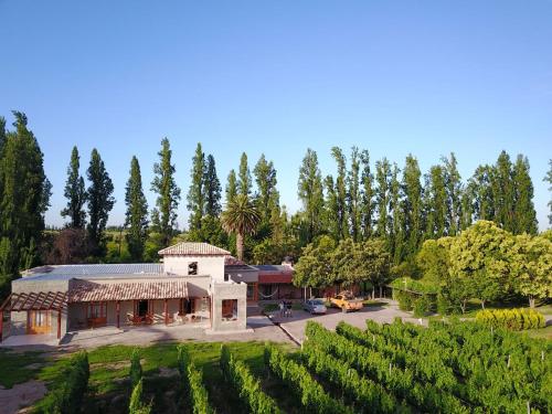 a large building with a tree in front of it at Posada Cavieres Wine Farm in Maipú