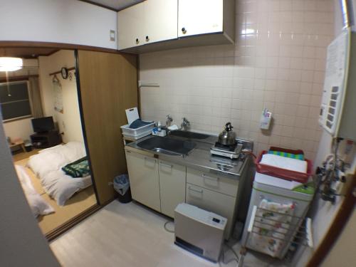 a small kitchen with a sink and a room at Kenroku Haitsu 205 in Kanazawa