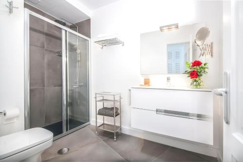 a bathroom with a shower and a toilet and a sink at Rooms & Suites The Lighthouse in Tías